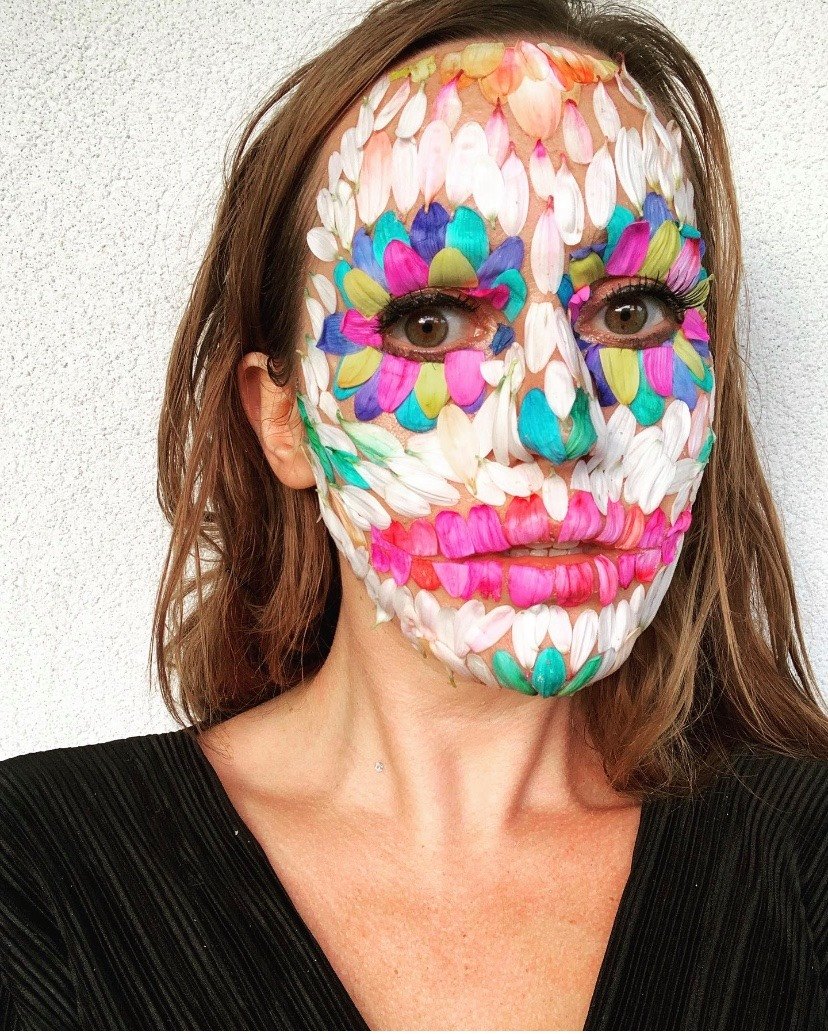 Face covered in a mosaic of real flower petals